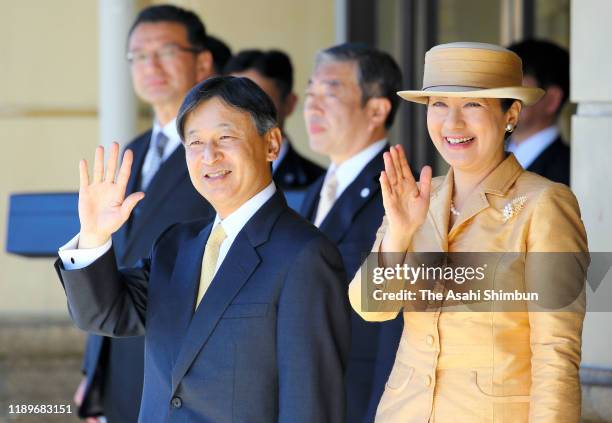 Emperor Naruhito and Empress Masako wave to well-wishers on departure at Uji Yamada Station after visiting the Ise Shrine on November 23, 2019 in...