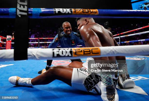 Referee Kenny Bayless gives a count to Luis Ortiz after he was knocked out in the seventh round by WBC heavyweight champion Deontay Wilder at MGM...