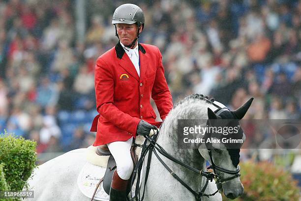 Jos Lansink of Belgium on his horse King Kolibri reacts during the Warsteiner jumping competition at the CHIO on July 13, 2011 in Aachen, Germany.