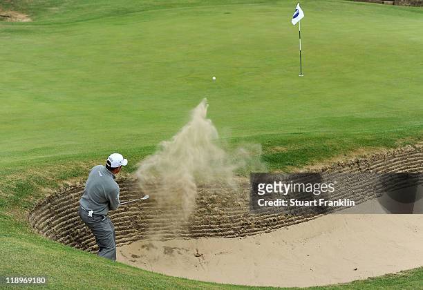 Lee Westwood of England plays a bunker shot during the final practice round during The Open Championship at Royal St. George's on July 13, 2011 in...