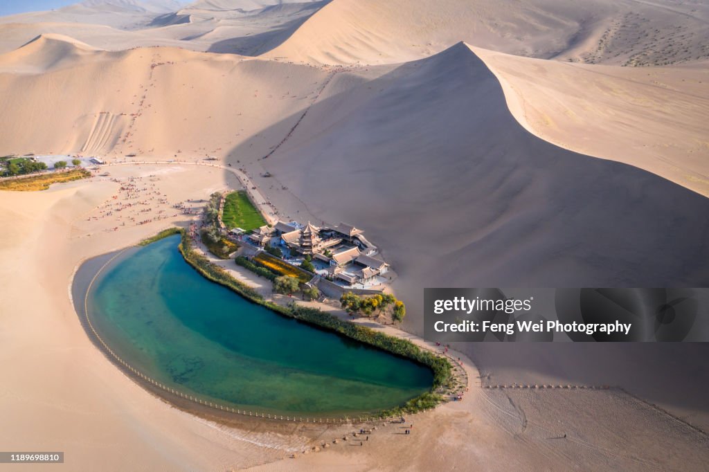 Crescent Lake with buddhist temple in Kumtag desert, Dunhuang, Gansu China