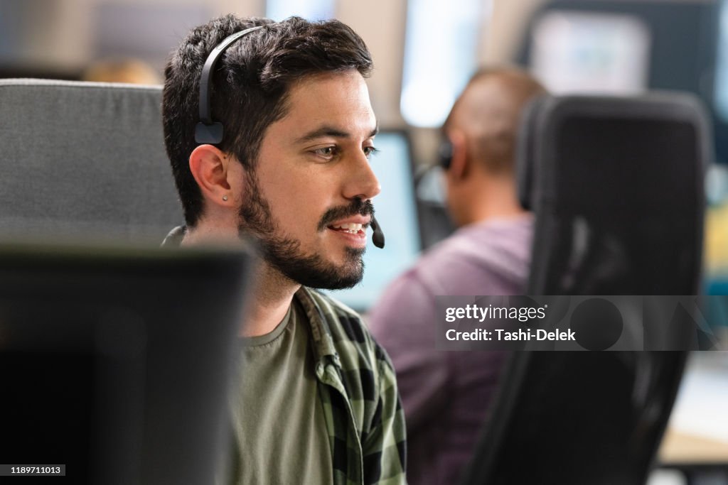Hombre hablando con un cliente a través de un auricular