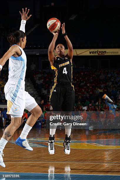 Amber Holt of the Tulsa Shock puts up a shot over Tamera Young of the Chicago Sky during the WNBA game on July 13, 2011 at the All-State Arena in...