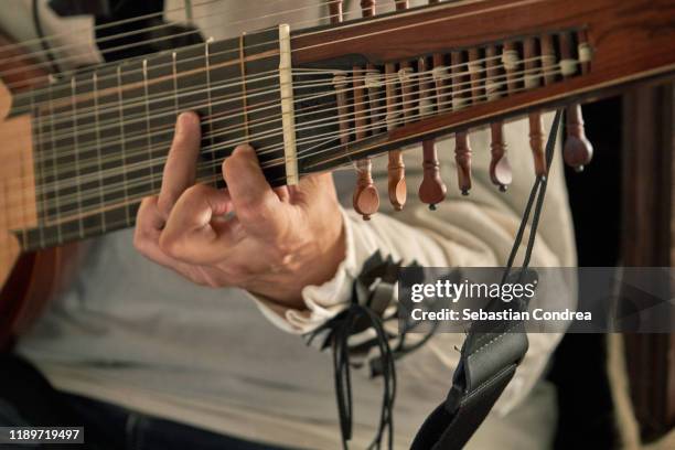 midsection of person singer on guitar. - arabic lutes stock pictures, royalty-free photos & images