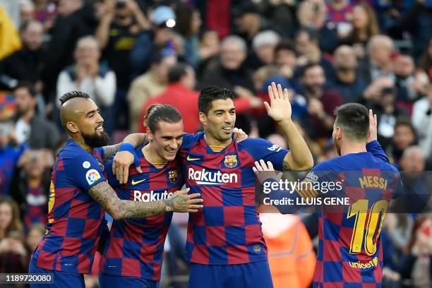 Barcelona's French forward Antoine Griezmann celebrates with Barcelona's Chilean midfielder Arturo Vidal, Barcelona's Uruguayan forward Luis Suarez...