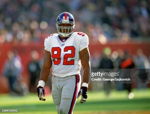 Defensive lineman Michael Strahan of the New York Giants looks on from the field during a game against the Cleveland Browns at Cleveland Browns...