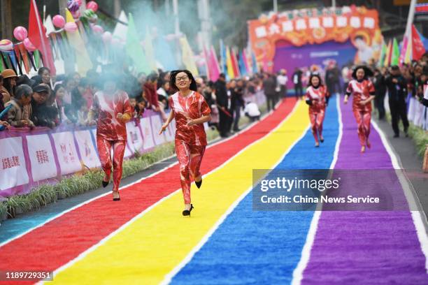Participants take part in a 100-meter high-heel race on November 23, 2019 in Chongqing, China.