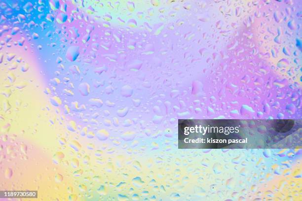 waterdrops on window glass with colourful background . - humidity stock pictures, royalty-free photos & images
