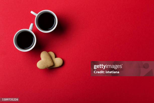 heart shaped cookies and coffee cups on red  background - love symbol #2 stock pictures, royalty-free photos & images