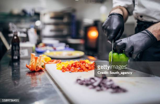 chef cutting paprika - glove imagens e fotografias de stock