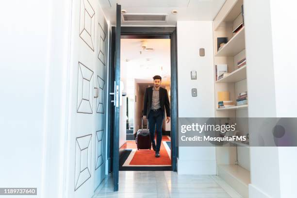 tired man arriving traveling in hotel room - hotel arrival stock pictures, royalty-free photos & images