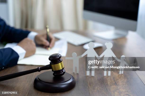 family figure and gavel on wooden table. family law concept - strict parent stock-fotos und bilder