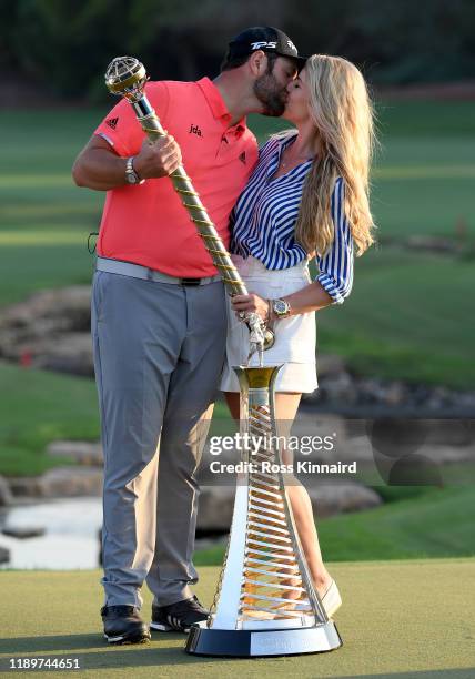 Jon Rahm of Spain poses with his fiance Kelley Cahill and the DP World Tour Championship trophy and the Race to Dubai trophy after the final round of...