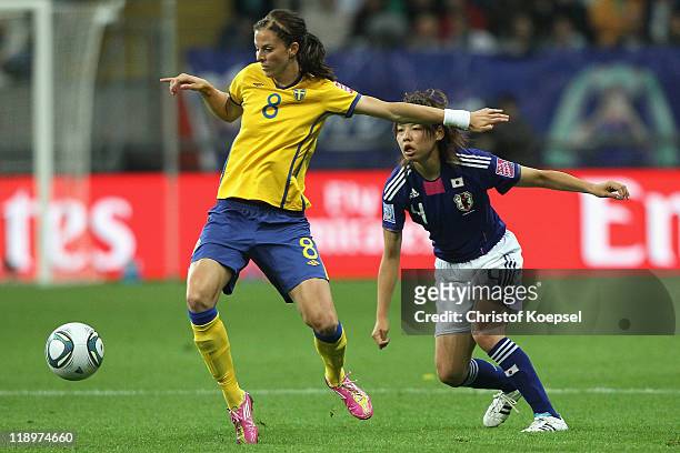 Saki Kumagai of Japan challenges Lotta Schelin of Sweden during the FIFA Women's World Cup Semi Final match between Japan and Sweden at the FIFA...