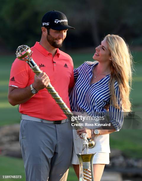 Jon Rahm of Spain poses with his fiance Kelley Cahill and the DP World Tour Championship trophy and the Race to Dubai trophy after the final round of...