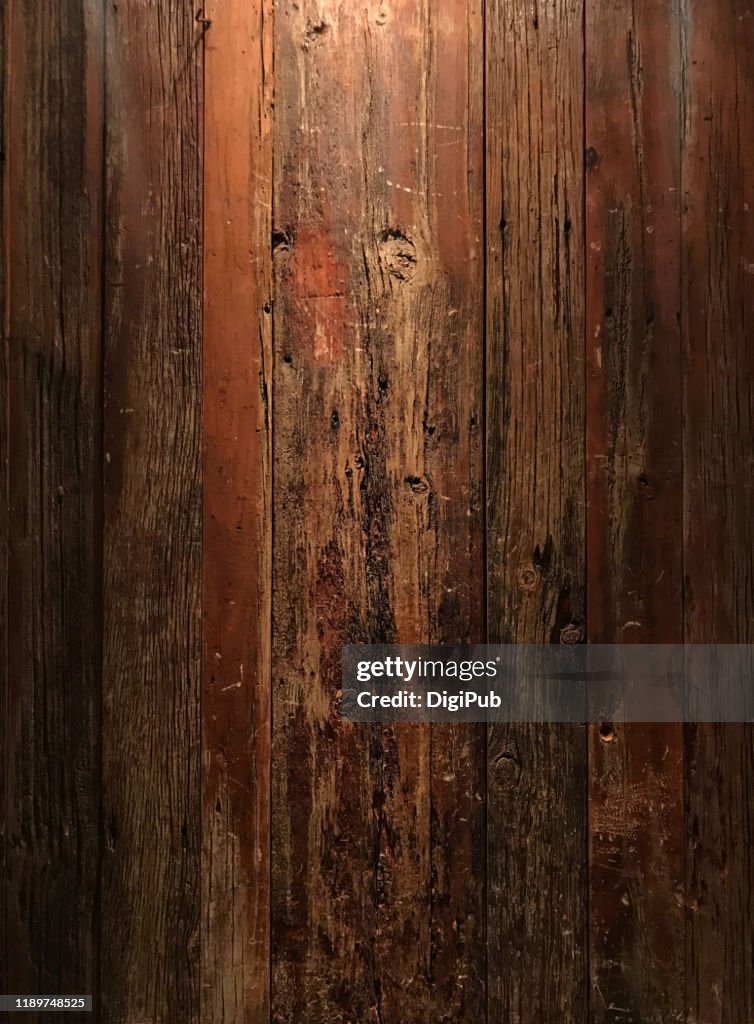 Weathered wood wall illuminated in the night