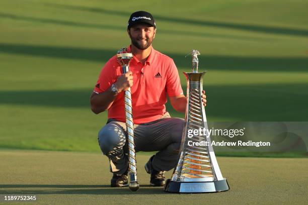 Jon Rahm of Spain poses with the DP World Tour Championship trophy and the Race to Dubai trophy following his victory during Day Four of the DP World...