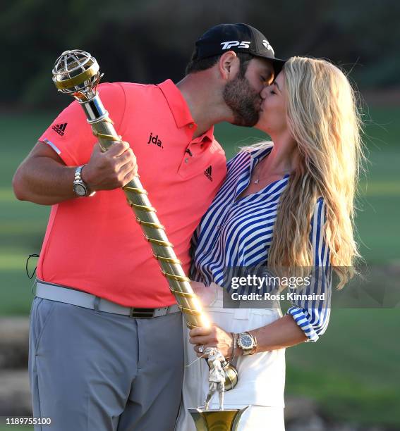 Jon Rahm of Spain poses with his fiance Kelley Cahill and the DP World Tour Championship trophy following his victory during Day Four of the DP World...