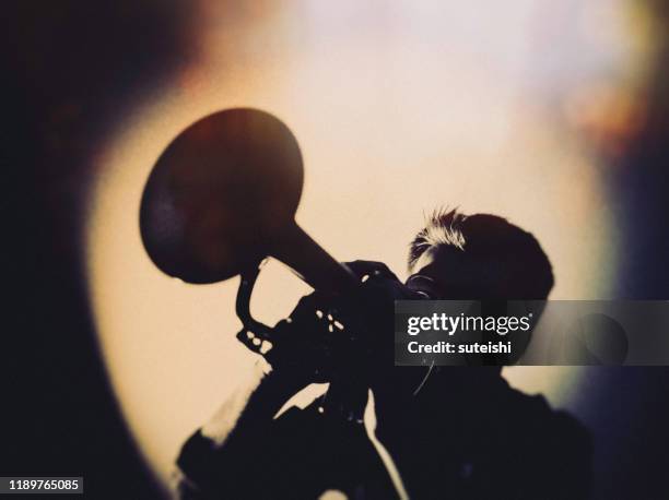 the trumpet player at the jazzclub - jazz stock-fotos und bilder