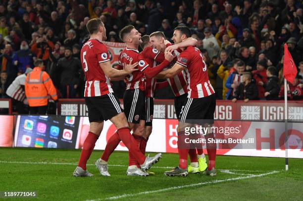 John Fleck of Sheffield United celebrates with teammates after scoring his sides first goal the Premier League match between Sheffield United and...