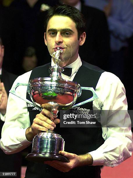 Ronnie O'sullivan of England kisses the trophy after beating John Higgins to win the final of the Embassy World Championship Snooker Finals at the...