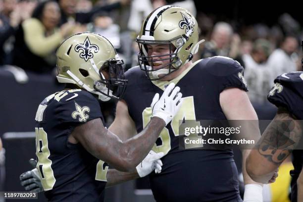 Latavius Murray of the New Orleans Saints celebrates with Kiko Alonso after scoring a 26 yard touchdown against the Carolina Panthers during the...