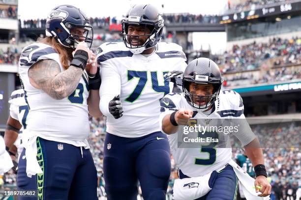 Quarterback Russell Wilson of the Seattle Seahawks celebrates in the end zone after throwing a first quarter touchdown pass against the Philadelphia...