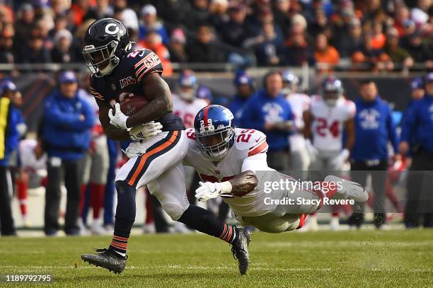Tarik Cohen of the Chicago Bears is pursued by Deone Bucannon of the New York Giants during the first half at Soldier Field on November 24, 2019 in...