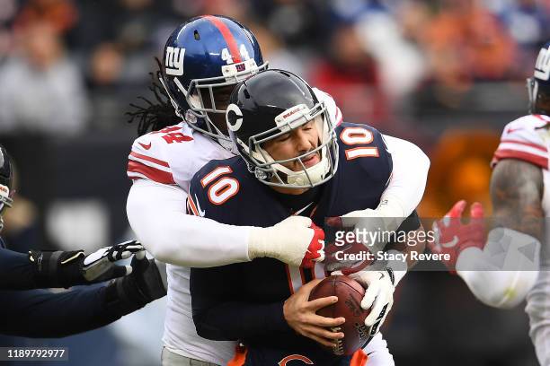 Mitchell Trubisky of the Chicago Bears is sacked by Markus Golden of the New York Giants during the first half at Soldier Field on November 24, 2019...