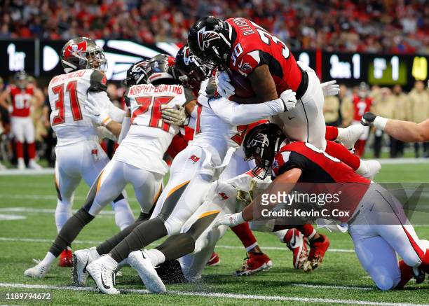 Qadree Ollison of the Atlanta Falcons dives for a touchdown against Lavonte David of the Tampa Bay Buccaneers in the first half at Mercedes-Benz...