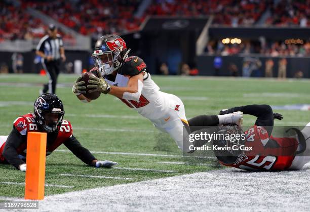 Scott Miller of the Tampa Bay Buccaneers is tackled by Deion Jones of the Atlanta Falcons short of the pylon at Mercedes-Benz Stadium on November 24,...