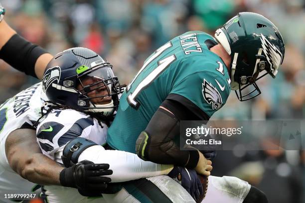 Quinton Jefferson and Ezekiel Ansah of the Seattle Seahawks sack quarterback Carson Wentz of the Philadelphia Eagles in the first half at Lincoln...