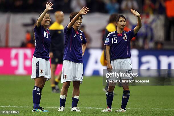 Homare Sawa, Kozue Ando and Aya Sameshima of Japan celebrate winning 3-1 the FIFA Women's World Cup Semi Final match between Japan and Sweden at the...