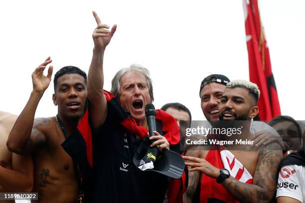 Jorge Jesus head coach of Flamengo talks to fans with players Gabriel Barbosa and Orlando Berrio as on a bus during the celebrations the day after...