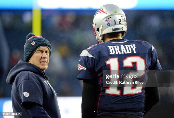 Head coach Bill Belichick of the New England Patriots talks with Tom Brady before the game against the Dallas Cowboys at Gillette Stadium on November...