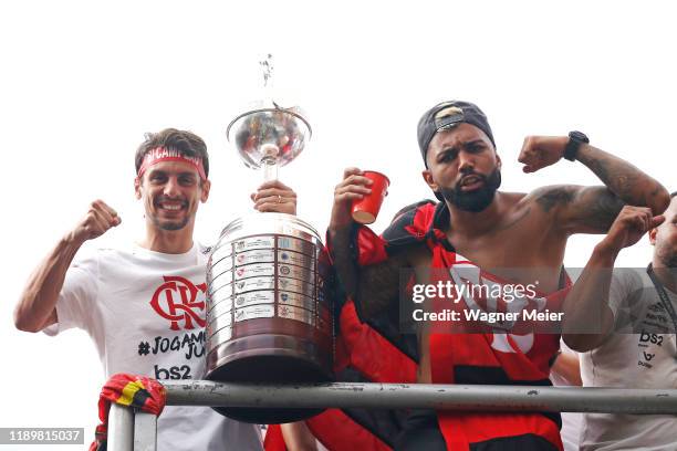 Rodrigo Caio and Gabriel Barbosa of Flamengo pose with the trophy on a bus during the celebrations the day after Flamengo won the Copa CONMEBOL...