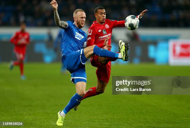 Kevin Voigt of Hoffenheim challenges Robin Quaison of Mainz during the Bundesliga match between TSG 1899 Hoffenheim and 1. FSV Mainz 05 at...