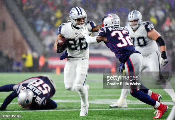 Tony Pollard of the Dallas Cowboys runs with the ball during the first half against Devin McCourty of the New England Patriots in the game at...
