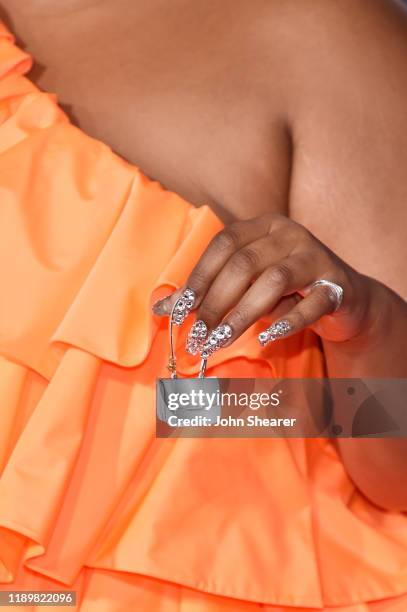 Lizzo, purse and manicure detail, attends the 2019 American Music Awards at Microsoft Theater on November 24, 2019 in Los Angeles, California.