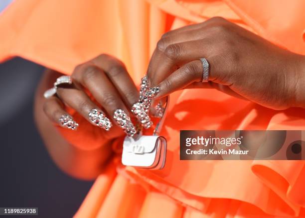 Lizzo, purse and manicure detail, attends the 2019 American Music Awards at Microsoft Theater on November 24, 2019 in Los Angeles, California.