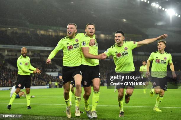 Sheffield United's English defender Jack O'Connell celebrates with teammates after scoring, but the goal was subsequently disallowed after a VAR...