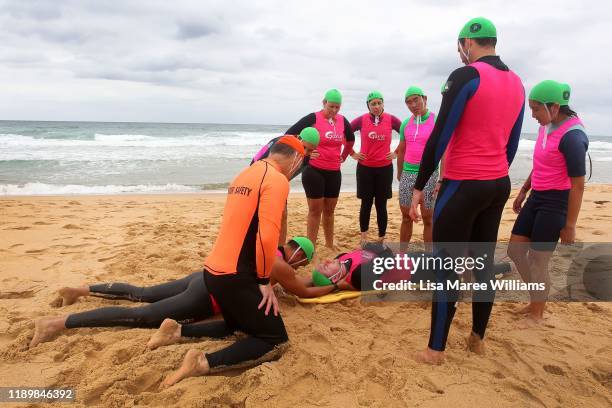 Instructor Brett Walker guides Garie Vanguard Surf Life Saving trainees as they perform a mock ocean rescue and resuscitation on November 24, 2019 at...