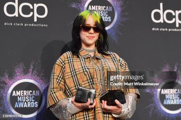 Billie Eilish, winner of the awards for Favorite Artist - Alternative Rock and New Artist of the Year, poses in the press room during the 2019...