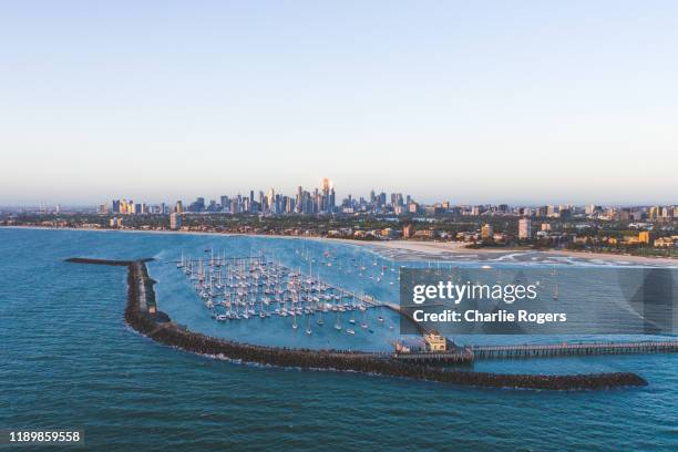 st kilda pier and melbourne skyline at sunset - st kilda bildbanksfoton och bilder