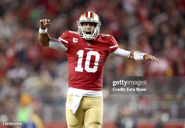 Jimmy Garoppolo of the San Francisco 49ers celebrates after Raheem Mostert ran in for a touchdown in the fourth quarter against the Green Bay Packers...