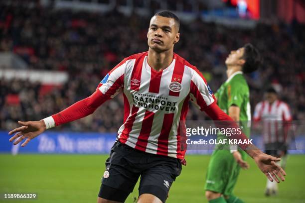 Eindhoven's Cody Gakpo celebrates after scoring a goal during the Dutch Eredivisie league football match between PSV Eindhoven and PEC Zwolle at the...