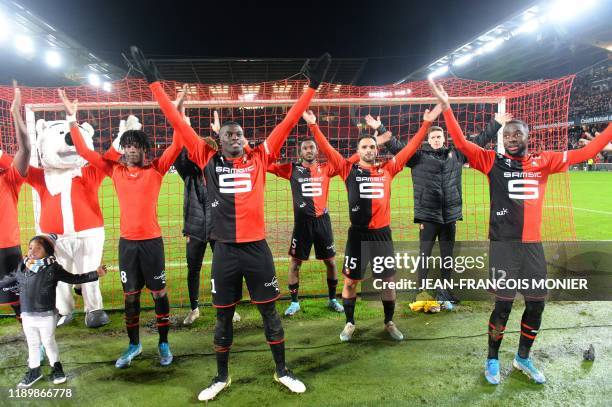 Rennes' players celebrate at the end of the French L1 football match between Stade Rennais Football Club and FC Girondins de Bordeaux at the Roazhon...