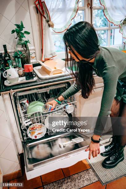 woman loading dishwasher - loading dishwasher stock pictures, royalty-free photos & images