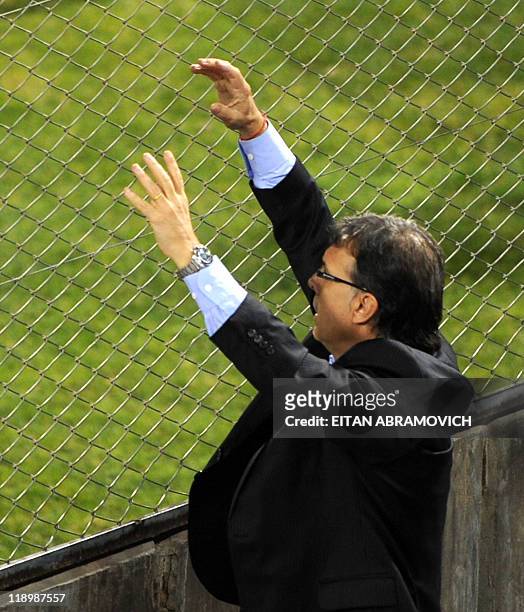 Paraguay's head coach Gerardo Martino gives instructions to his players from behind a fence, during the 2011 Copa America Group B first round...