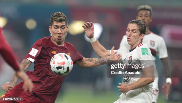 Roberto Firmino of Liverpool in action against Filipe Luis of CR Flamengo during the FIFA Club World Cup Qatar 2019 Final match between Liverpool FC...